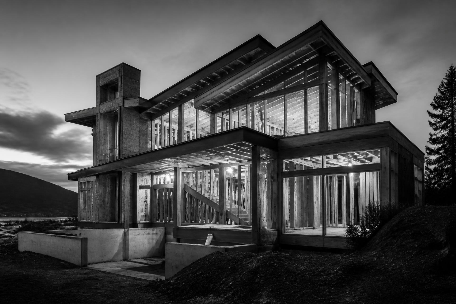 Custom framed luxury home under construction in the Greater Toronto Area at dusk